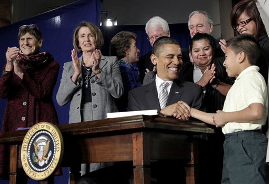 President Obama shakes hands with third-grader Luis Avilar-Turcios, 8, after signing the Healthy, Hunger-Free Act of 2010 during a ceremony at the Harriet Tubman Elementary School in Washington's Columbia Heights neighborhood on Monday, Dec. 13, 2010. Rep. Rosa DeLauro (left), Connecticut Democrat, and House Speaker Nancy Pelosi, California Democrat, were among the dignitaries applauding the signing. (AP Photo/Pablo Martinez Monsivais)