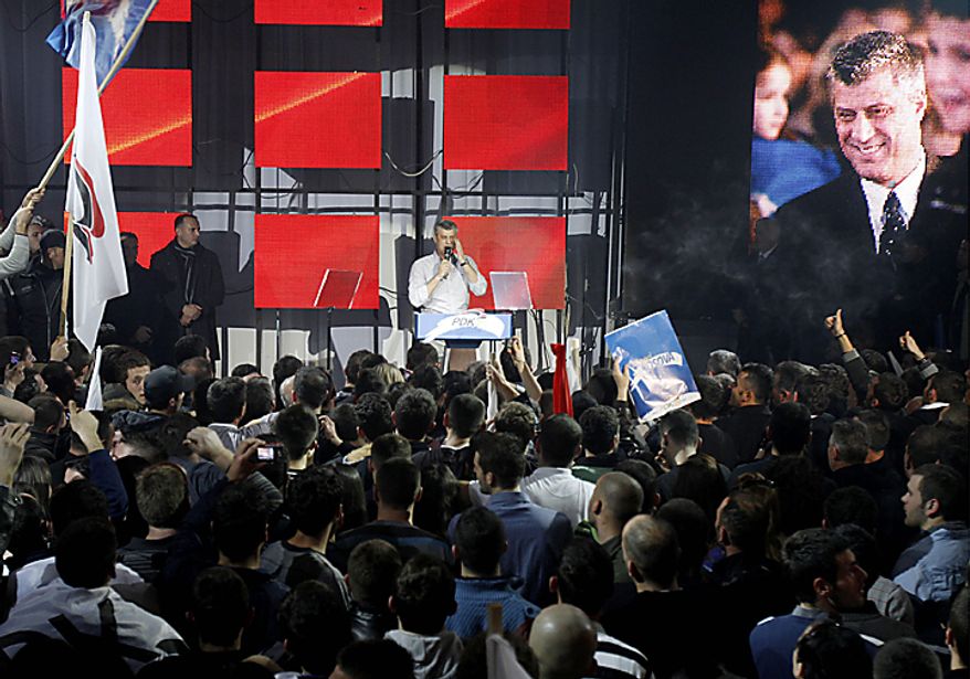 Kosovo's Prime Minister and leader of Democratic Party of Kosovo (PDK) Hashim Thaci, rear, speaks at his supporters celebrating victory in capital Pristina on Sunday, Dec. 12, 2010. Thaci has claimed victory in Kosovo's first general election since the province declared independence from Serbia, as an independent exit poll showed his Democratic Party of Kosovo 6 percentage points ahead of its rivals. (AP Photo/Visar Kryeziu)