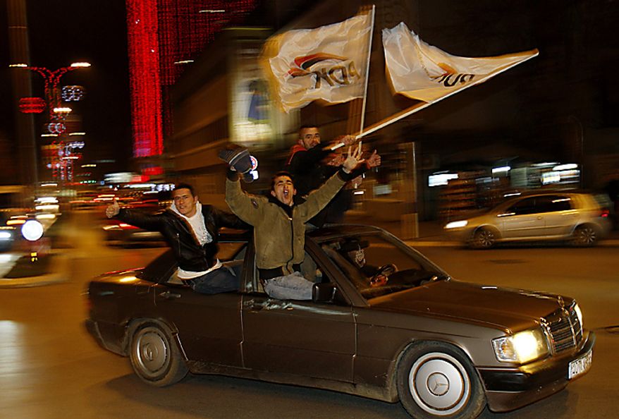 Supporters of the Democratic Party of Kosovo (PDK) celebrate the party's victory in Pristina, Kosovo, on Sunday, Dec. 12, 2010. Incumbent Prime Minister Hashim Thaci claimed victory Sunday in Kosovo's first general election since the province declared independence from Serbia, as an independent exit poll showed his Democratic Party of Kosovo 6 percentage points ahead of its rivals. (AP Photo/Visar Kryeziu)