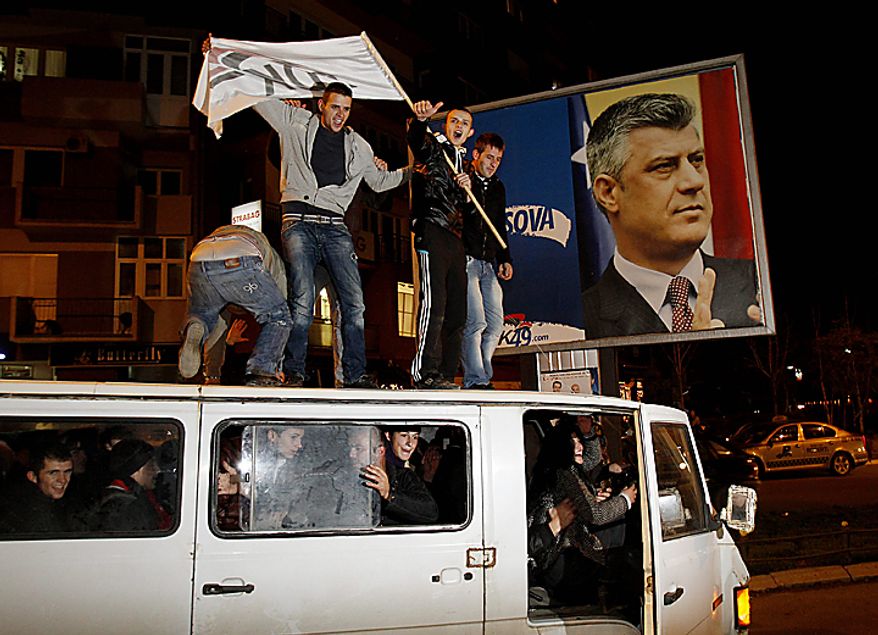 Supporters of the Democratic Party of Kosovo (PDK) celebrate the party's victory in Pristina, Kosovo, on Sunday, Dec. 12, 2010. Incumbent Prime Minister Hashim Thaci, seen in photo on poster, claimed victory Sunday in Kosovo's first general election since the province declared independence from Serbia, as an independent exit poll showed his Democratic Party of Kosovo 6 percentage points ahead of its rivals. (AP Photo/Visar Kryeziu)