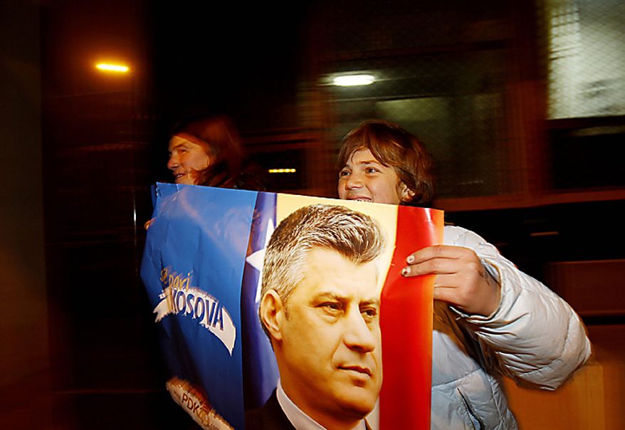 Supporters of the Democratic Party of Kosovo (PDK) celebrate the party's victory in Pristina, Kosovo, on Sunday, Dec. 12, 2010. Incumbent Prime Minister Hashim Thaci, seen in photo on poster, claimed victory Sunday in Kosovo's first general election since the province declared independence from Serbia, as an independent exit poll showed his Democratic Party of Kosovo 6 percentage points ahead of its rivals. (AP Photo/Visar Kryeziu)