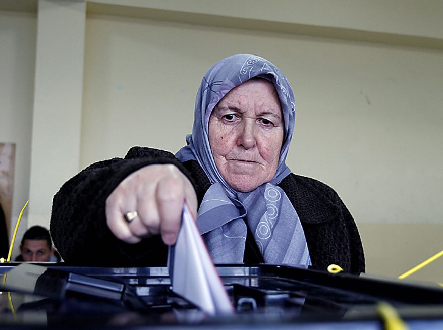 A Kosovo Albanian woman votes at a polling station during general elections in the town of Hajvalia on Sunday, Dec. 12, 2010. Kosovars are voting Sunday in the first general poll since the country's declaration of independence from Serbia in 2008, a critical election already marred by ethnic tension that many fear will split the world's newest country. (AP Photo/Visar Kryeziu)