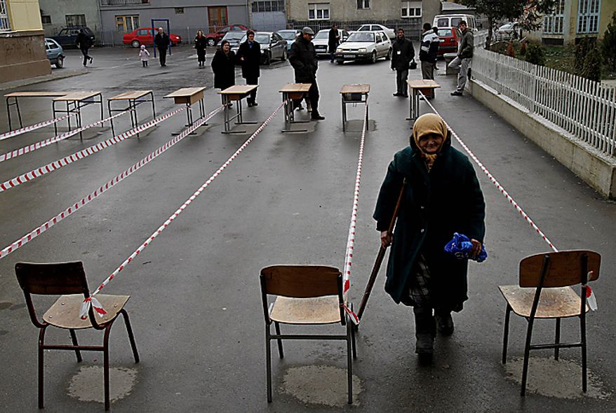 A Kosovo woman arrives at a polling station to cast her ballot in general elections in Kosovo's capital Pristina on Sunday, Dec. 12, 2010. Kosovars vote in the first general poll since the country's declaration of independence from Serbia in 2008, a critical election already marred by ethnic tension that many fear will split the world's newest country. (AP Photo/Visar Kryeziu)