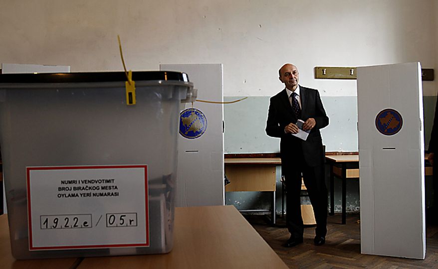 Leader of Democratic League of Kosovo (LDK) Isa Mustafa, casts his ballot in general elections in Kosovo capital Pristina on Sunday, Dec. 12, 2010. Kosovars vote in the first general poll since the country's declaration of independence from Serbia in 2008, a critical election already marred by ethnic tension that many fear will split the world's newest country. Some 1.6 million voters are eligible to vote for 29 political parties, coalitions and citizens' initiatives to enter Kosovo's 120-seat parliament. (AP Photo/Visar Kryeziu)