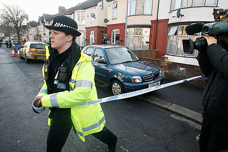 A police officer cordons off the area before a car, center, is removed from outside the house which was searched by British police in Luton, England, Monday, Dec. 13, 2010. A Swedish prosecutor says police are "98 percent" certain the Stockholm suicide bomber is 28-year-old Taimour Abdulwahab who is a Swedish citizen but also lived several years in Britain. Prosecutor Tomas Lindstrand Monday said Abdulwahab has his roots in the Middle East and has been a Swedish citizen since 1992. Lindstrand said Abdulwahab was also the registered owner of the car that exploded in Stockholm shortly before the suicide blast Saturday. (AP Photo/Akira Suemori)