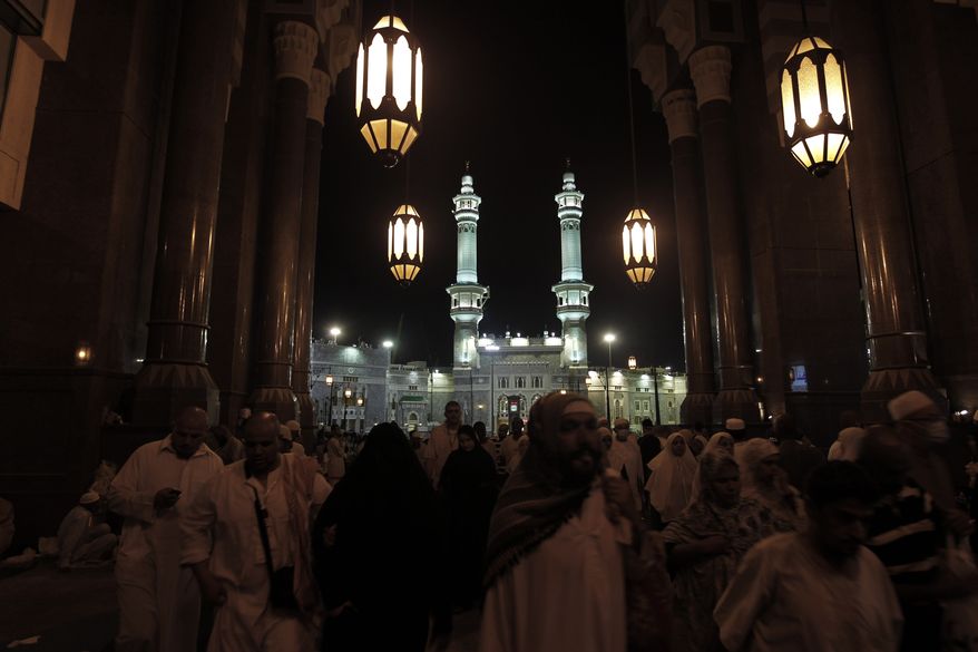 Muslim pilgrims leaving the Grand Mosque after a prayer, during the annual Hajj in Mecca, Saudi Arabia, Thursday, Nov. 18, 2010. The U.S. government sued a suburban Chicago school district on Monday, Dec. 13, 2010, for denying a Muslim teacher leave to go on the pilgrimage. (AP Photo/Hassan Ammar)