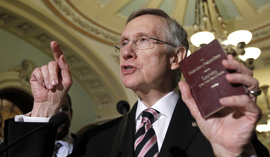 Senate Majority Leader Sen. Harry Reid of Nev., holds a copy of the Constitution and Declaration of Independence during a news conference on Capitol Hill in Washington Thursday, Dec. 16, 2010. (AP Photo/Alex Brandon)