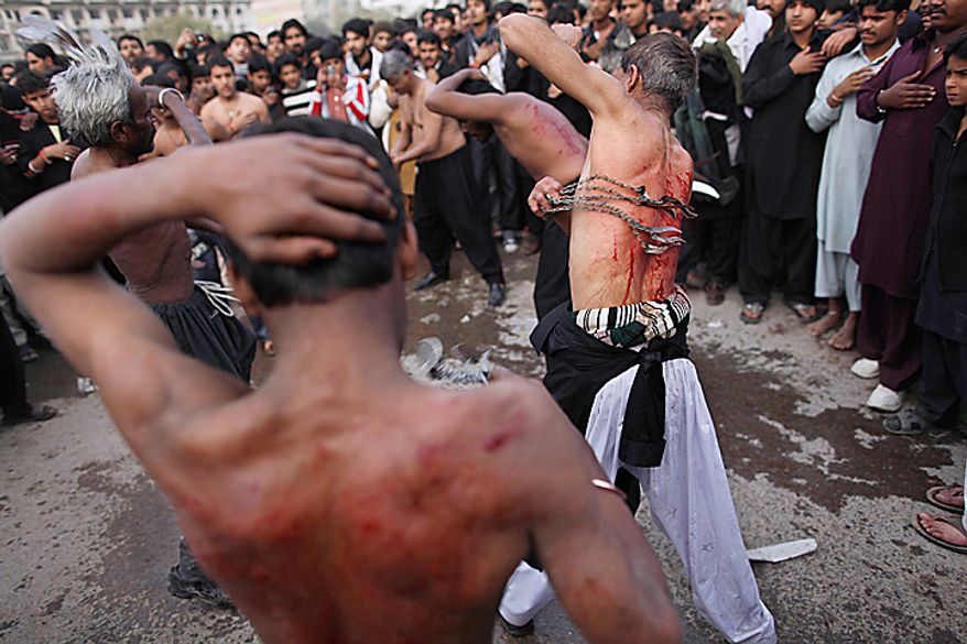 Shi'ite men flagelate themselves with knives during a Muharram procession in Islamabad, Pakistan, Thursday, Dec. 16, 2010. Muharram is a ten-day mourning period observed by Shi'ites around the world in remembrance of the martyrdom of Imam Hussein, the grandson of Prophet Muhammad. (AP Photo/Muhammed Muheisen)