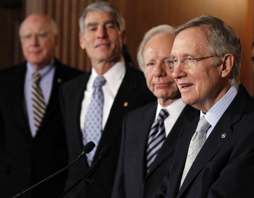 Senate Majority Leader Sen. Harry Reid, Nevada Democrat, from right, speaks as he stands with Sen. Joe Lieberman, Connecticut Independent, Sen. Mark Udall, Colorado Democrat, and Sen. Patrick J. Leahy, Vermont Democrat, at a press conference about the &quot;Don&#39;t Ask Don&#39;t Tell&quot; bill during an unusual Saturday session on Capitol Hill in Washington Saturday, Dec. 18, 2010.(AP Photo/Alex Brandon)