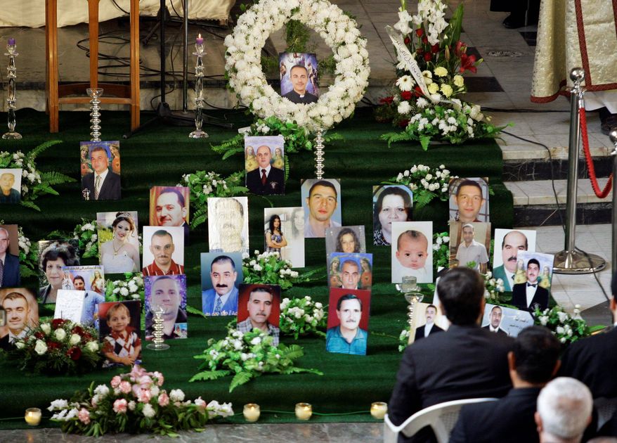 Pictures of slain Iraqi Christians are displayed during Mass Dec. 10 at Our Lady of Salvation church in Baghdad. Sixty-eight persons died in a bombing there on Oct. 31, and days later, a string of bombs went off outside Christian homes in the city. (Associated Press)
