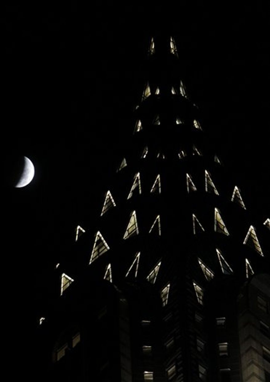 A series of photos taken over an hour long period show the full moon as it is shadowed by the Earth as a total lunar eclipse marks the arrival of the winter solstice Tuesday, December 21, 2010 in Overland Park, Kan. (AP Photo/Charlie Riedel)
