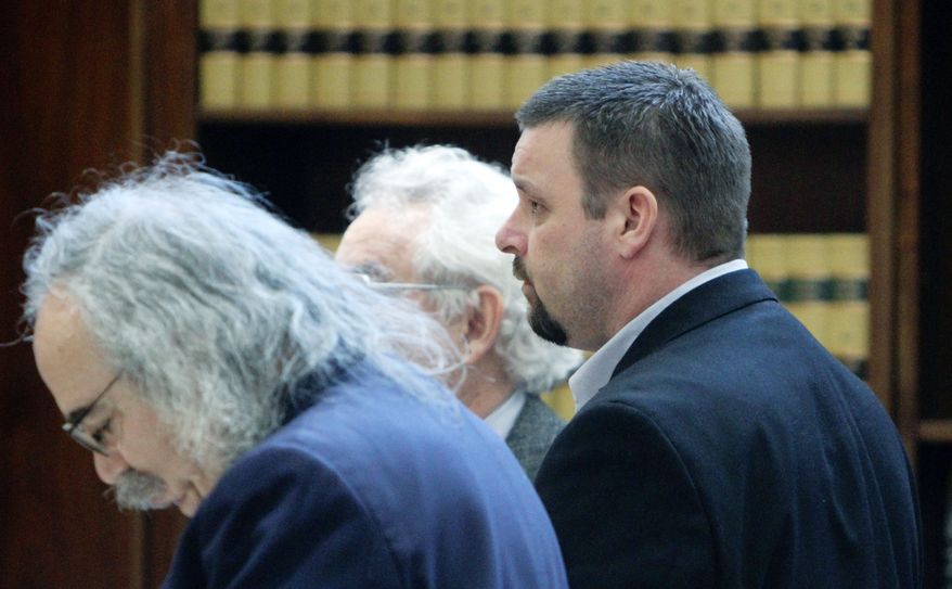 Joshua Turnidge (center) stands with his attorneys on Wednesday in Marion County Circuit Court in Salem, Ore. A jury has handed down death sentences for Bruce Turnidge and his son, Joshua.