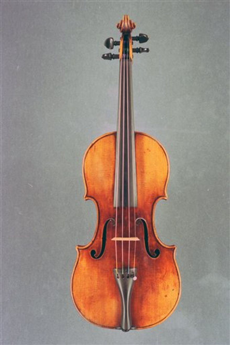 An undated image released by the British Transport Police on Thursday Dec. 23, 2010, of a 1697 Stradivarius violin. Three people were arrested for stealing a 1.2 million-pound ($1.85 million) antique violin from a musician while she stopped for a snack at a London sandwich bar, British police said Thursday. South Korean violinist Min-Jin Kym was eating inside the sandwich shop outside Euston station on Nov. 29 when she noticed that her black violin case _ whch contained the 300-year-old Stradivarius as well as two expensive bows _ was missing, police said. The violin, made in 1696, is one of only around 400 in the world. It was stolen along with a Peccatte bow, valued at 62,000 pounds, and another bow worth more than 5,000 pounds. (AP Photo/British Transport Police)