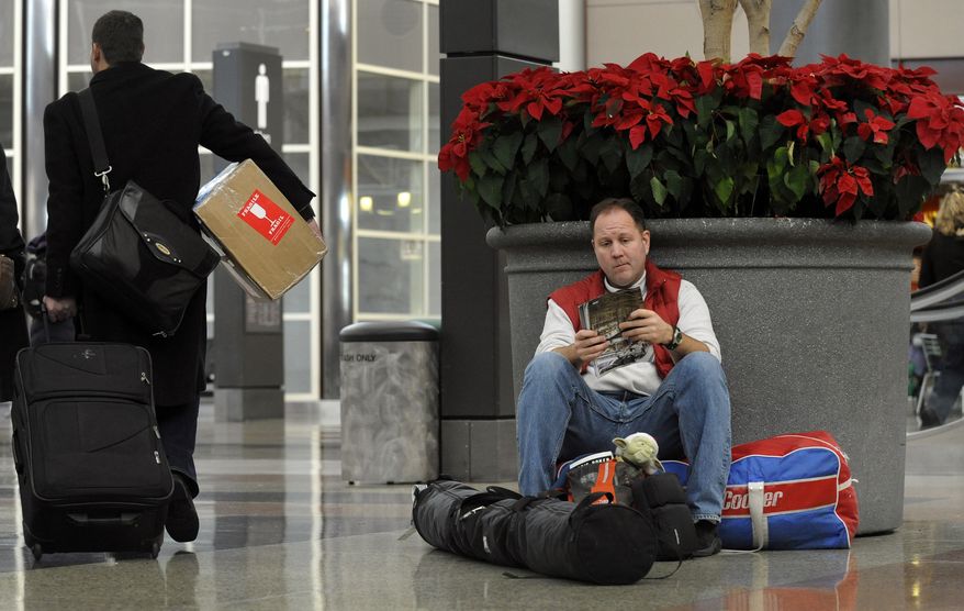 Hank Ritchie of San Francisco waits for his family to arrive at Denver International Airport in Denver on Friday, Dec. 24, 2010. (AP Photo/The Denver Post, Craig F. Walker)
