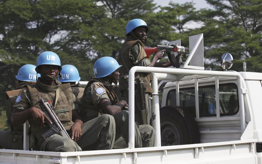 ** FILE ** U.N. forces patrol a street in Abidjan, Ivory Coast, on Thursday, Dec. 23, 2010. (AP Photo/Sunday Alamba)