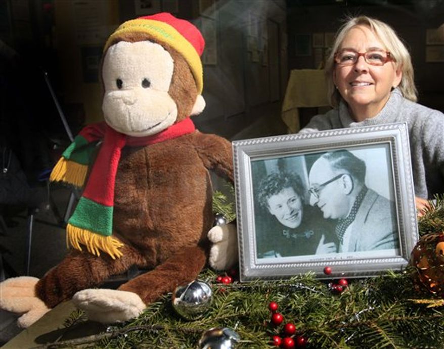 In this Dec. 17, 2010 photo, the cover of the book "The Journey That Saved Curious George" with an illustration showing Margret and H.A. Rey fleeing Paris on bicycles is seen at the Margret and H.A. Rey Center in Waterville Valley, N.H. The Rey's were the authors of many Curious George children's books in the 1940's. Louise Borden has written her own children's book about the Rey's, both jews, who escaped France, came to the United States, and built a summer home in Waterville Valley. (AP Photo/Jim Cole)