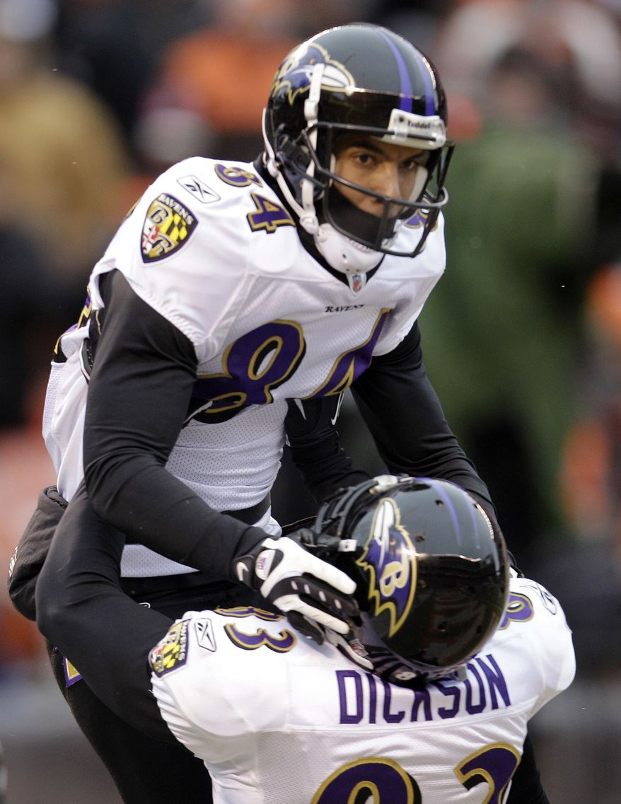 Baltimore Ravens wide receiver T.J. Houshmandzadeh, top, celebrates his 15-yard touchdown catch against the Cleveland Browns with tight end Ed Dickson in the second quarter of an NFL football game Sunday, Dec. 26, 2010, in Cleveland. (AP Photo/Tony Dejak)