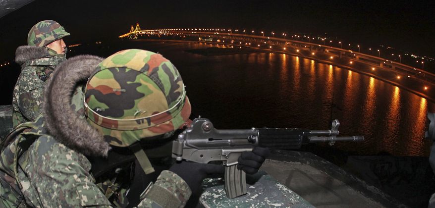South Korean soldiers man a guard post near the Incheon Bridge (right) in Incheon, South Korea, on Monday, Dec. 27, 2010. North Korea's belligerence is expected to deepen next year as the country undergoes a hereditary transfer of power, with Pyongyang waging more attacks on front-line South Korean islands and possibly conducting a third nuclear bomb test, a state-run think tank in Seoul said in a report posted online Monday. (AP Photo/Yonhap, Lee Jung-hoon)