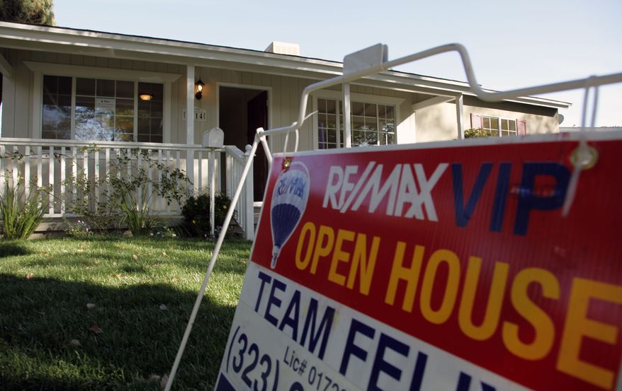 In this Nov. 4, 2010, photo, an open house sign is seen on the front lawn of a home for sale in Los Angeles. Home prices are dropping in the nation's largest cities and are expected to fall through next year, with the worst declines coming in areas with high numbers of foreclosures.(AP Photo/Richard Vogel)