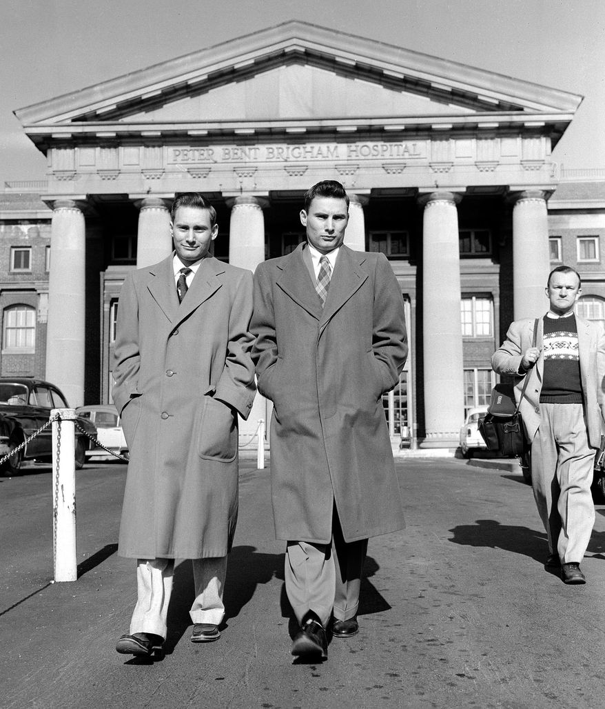 Richard Herrick, left, and his twin brother, Ronald, leave Peter Bent Brigham Hospital, later known as Brigham and Women's Hospital, in Boston, on Jan. 30, 1955, after fully recovering from a Dec. 23, 1954, kidney transplant that was recognized as the world's first successful organ transplant. Richard lived eight years after receiving the transplant. Ronald, who donated the kidney, died Monday, Dec. 27, 2010, in Augusta, Maine. He was 79. (AP Photo/File)