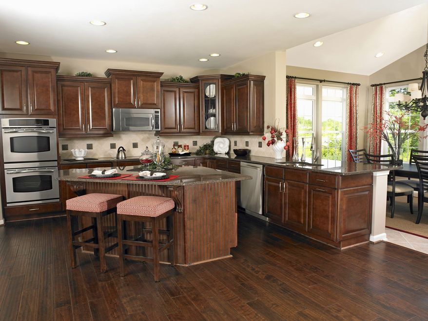 The Heath model at the Springs at Lenah includes a gourmet kitchen with a center island and stainless steel appliances. The kitchen opens into the breakfast area and has an adjacent family room. The Heath is priced from $609,990.