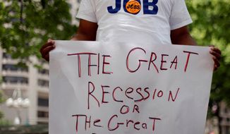 Frank Wallace, unemployed since May of 2009, holds a sign during a rally in June organized by the Philadelphia Unemployment Project. (Associated Press)