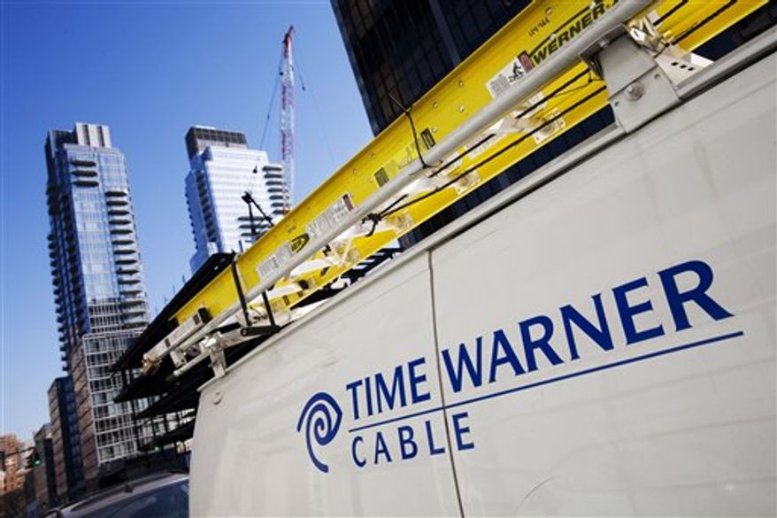 FILE - In this Feb. 2, 2009 file photo, a Time Warner Cable truck is parked in New York. Time Warner Cable Inc. customers from Portland, Maine, to Pensacola, Fla., could lose access to one of their network TV stations 12:00 a.m. EST Saturday, Jan. 1, 2011, because of a contract dispute with Sinclair Broadcast Group. (AP Photo/Mark Lennihan, file)