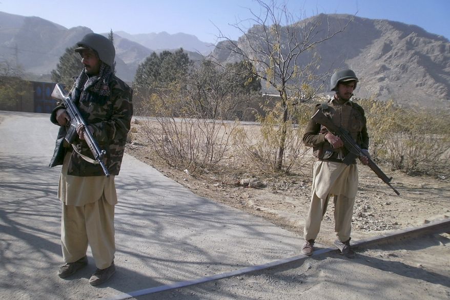 Pakistani paramilitary soldiers stand guard at a checkpoint in Sadukheil village near Landi Kotel, in Pakistan's Khyber Tribal region along Afghan border on Saturday, Dec. 18, 2010. Three American missile attacks killed 54 alleged militants on Friday in the Khyber tribal region close to the Afghan border, an unusually high number of victims that included commanders of a Taliban-allied group that were holding a meeting, Pakistani officials said. (AP Photo/Amir Zada)