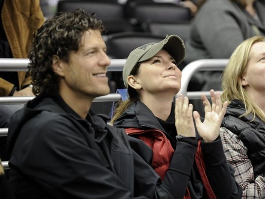 FILE - In this Nov. 6, 2010 file photo, singer Shania Twain sits with Frederic Thiebaud, left, during the third period of an NHL hockey game between the Nashville Predators and the Los Angeles Kings in Los Angeles. The country singer and businessman had a New Year's Day wedding in Puerto Rico on Saturday, Jan. 1, 2011. (AP Photo/Gus Ruelas, file)