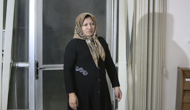 ** FILE ** Iranian Sakineh Mohammadi Ashtiani, who has been sentenced to death by stoning for adultery, arrives for a news briefing in the northwestern Iranian city of Tabriz on Saturday, Jan. 1, 2011. (AP Photo/Vahid Salemi)