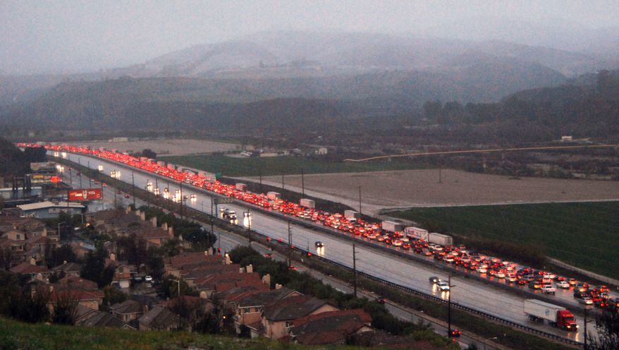 Red taillights of slow and stopped traffic glow on northbound Interstate 5 near Castaic, Calif., after heavy snow closed the major north-south several miles north of this point Sunday, Jan. 2 2011. (AP Photo/Mike Meadows)