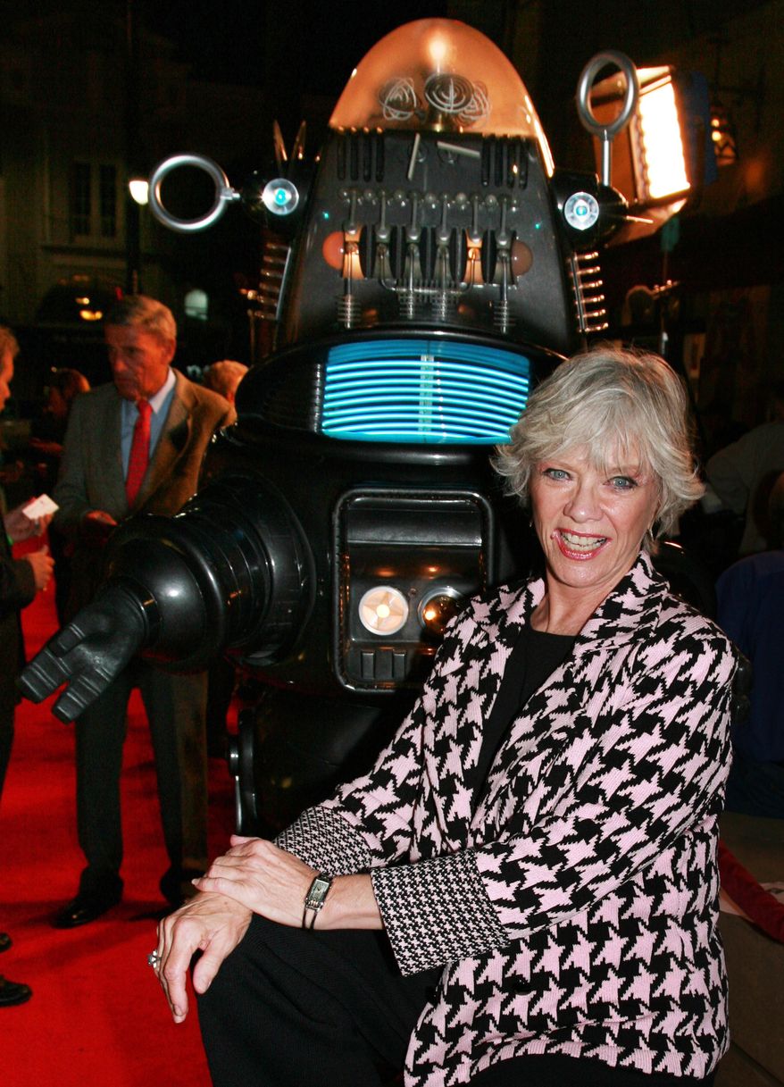 ** FILE ** Actress Anne Francis poses with Robby the Robot at a 2006 screening to commemorate the 50th anniversary of the science-fiction classic "Forbidden Planet" in Los Angeles. Miss Francis, who was the love interest in that movie and later was sexy private eye Honey West on TV, has died at age 80. (AP Photo/Warner Home Video, Alan Berliner, File )