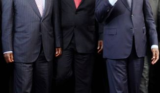 Kenyan Prime Minister Raila Odinga (left), Sierra Leone President Ernest Bai Koroma (center) and Ivory Coast President Laurent Gbagbo (right) meet in Abidjan on Monday. (Associated Press)