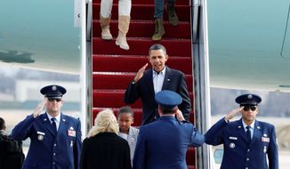 President Obama returns a salute as he and daughter Sasha arrive with his wife, Michelle, and other daughter Malia at Andrews Air Force Base in Maryland on Tuesday after nearly two weeks of vacation in Hawaii. (Associated Press)