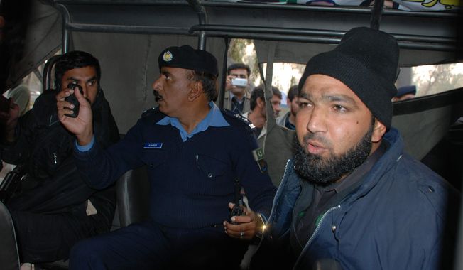 Commando of Pakistan&#x27;s Elite force, Mumtaz Qadri, right, who purportedly killed Punjab&#x27;s governor Salman Taseer, sits in a police custody in Islamabad, Pakistan on Tuesday, Jan. 4, 2011. (AP Photo/Irfan Ali)