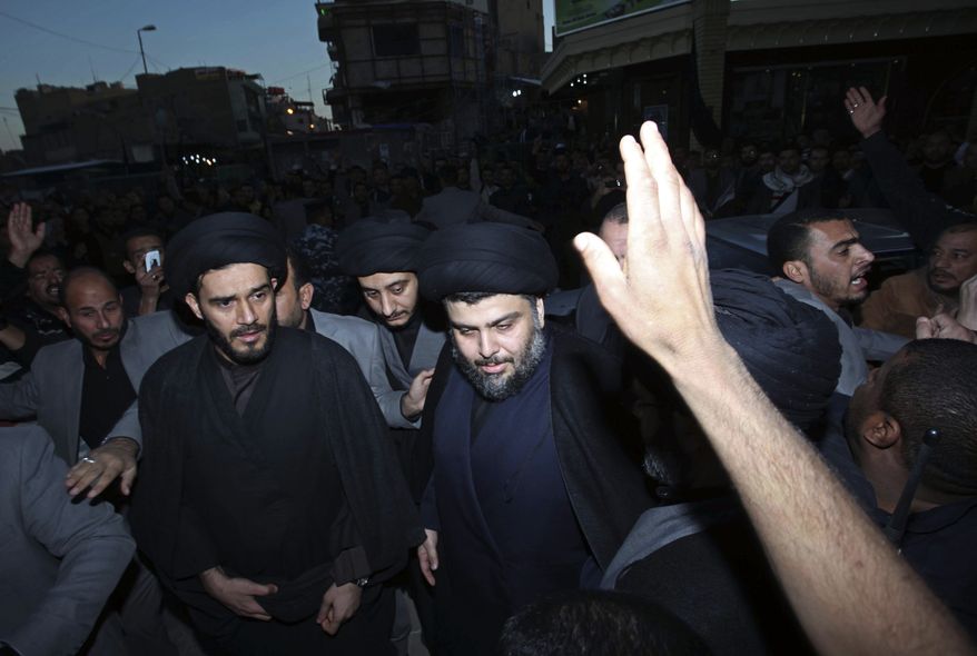 Anti-American cleric Muqtada al-Sadr, center, is surrounded by supporters in the Shi'ite city of Najaf, 100 miles south of Baghdad, Iraq, Wednesday, Jan. 5, 2011. Mr. al-Sadr, who led several Shi'ite uprisings against American forces in Iraq before going into exile in neighboring Iran almost four years ago, returned to Iraq Wednesday. (AP Photo/Alaa al-Marjani)