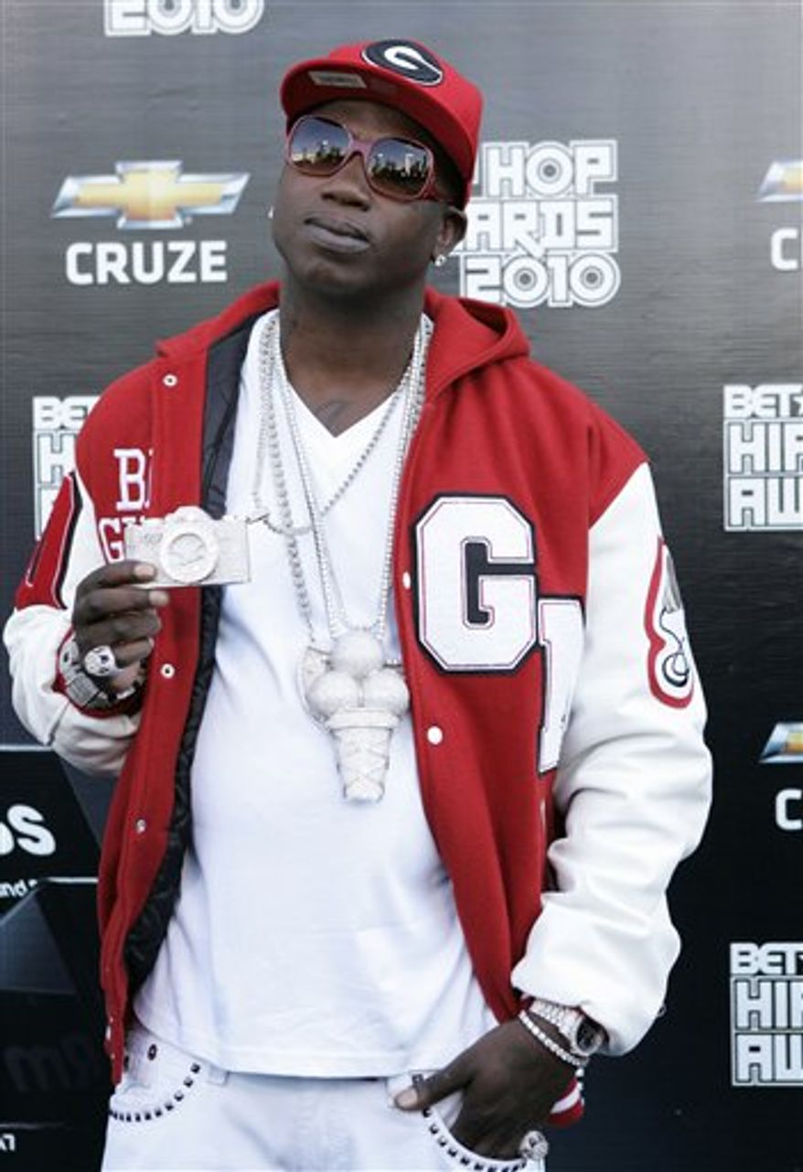 FILE - In this Oct. 2, 2010 file photo, rapper Gucci Mane arrives on the red carpet for the BET Hip Hop Awards in Atlanta. Fulton County Superior Court Judge John Goger ordered the rapper back to prison Monday, Jan. 3, 2011 for violating his probation in an altercation during a November traffic stop. The rapper, whose real name is Radric Davis, faces a Jan. 24 hearing and could face months in prison. (AP Photo/John Amis, file)
