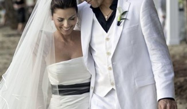 In this Jan. 1, 2011 publicity image released by Sandbox Entertainment, country singer Shania Twain, left, and her husband Frederic Thiebaud are shown on their wedding day in Rincon, Puerto Rico.  (AP Photo/Sandbox Entertainment) NO SALES, FOR EDITORIAL USE ONLY