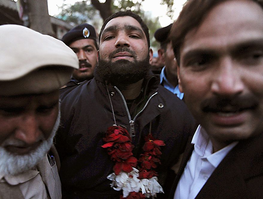 Mumtaz Qadri, center, the accused killer of Punjab Gov. Salman Taseer, arrives at court in Islamabad, Pakistan, on Wednesday, Jan. 5, 2011. More than 500 Muslim scholars praised the man suspected of killing the Pakistani governor because the politician opposed blasphemy laws that mandate death for those convicted of insulting Islam. The group of scholars and clerics known as Jamat Ahle Sunnat is affiliated with a moderate school of Islam and represents the mainstream Barelvi sect. The group said in a statement Wednesday that no one should pray for Mr. Taseer or express regret for his murder. (AP Photo/B.K.Bangash)