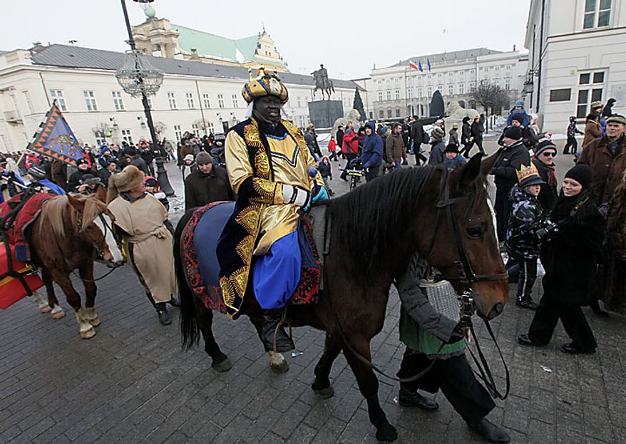 A volunteer dressed as one of the three kings carries gifts during the Epiphany parade through Warsaw on Thursday, Jan. 6, 2011. Poland observed Epiphany as an official public holiday for the first time in 50 years. The Epiphany feast day celebrates the visit of the three kings to the infant Jesus. (AP Photo/Czarek Sokolowski)