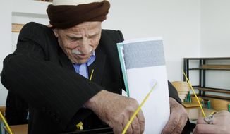 A Kosovo man casts his ballot at a polling station in the village of Zabelj in central Kosovo on Sunday. (Associated Press)