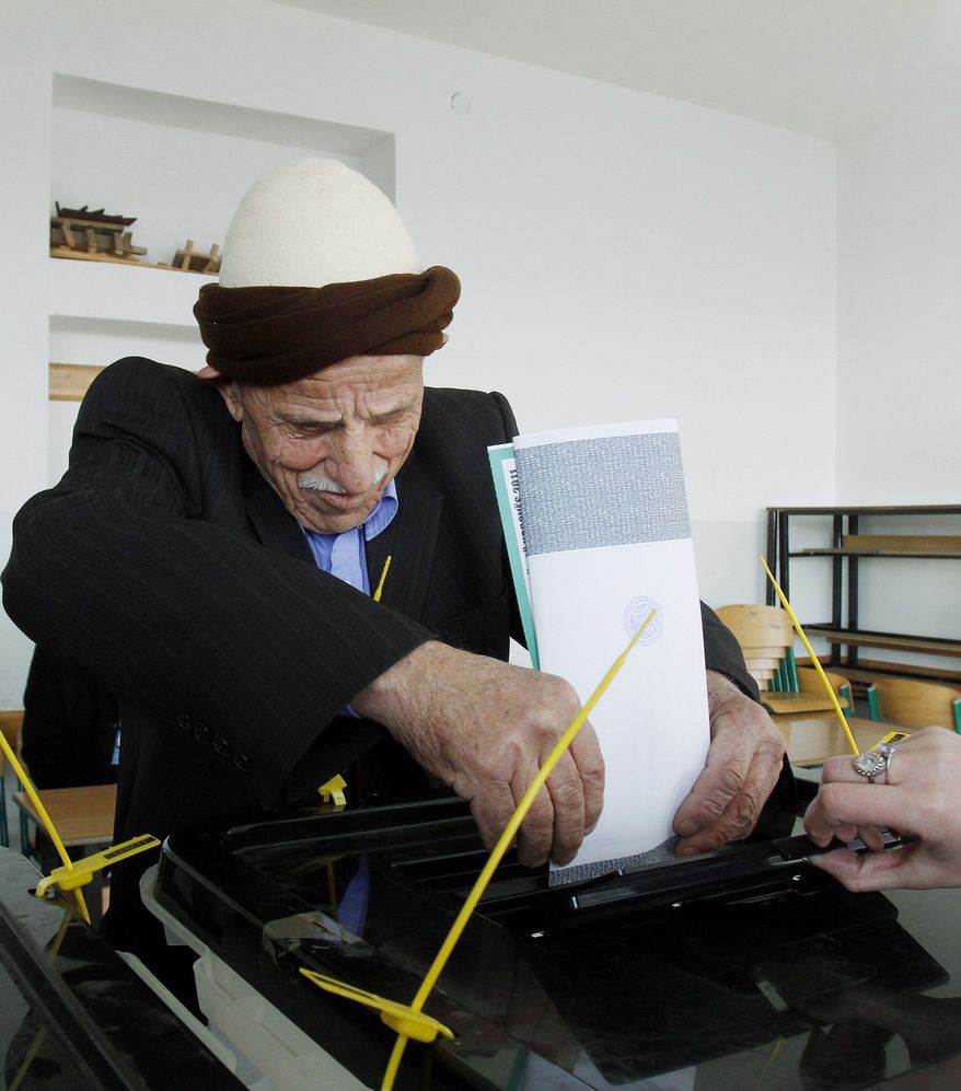 A Kosovo man casts his ballot at a polling station in the village of Zabelj in central Kosovo on Sunday. (Associated Press)