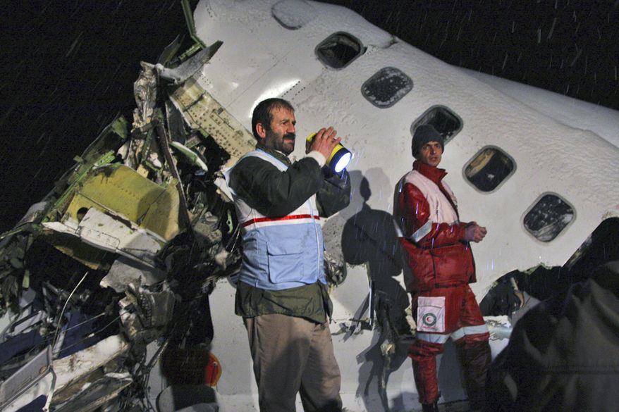 In this picture released by the Mehr news agency, rescue workers attend the scene Sunday after an IranAir Boeing 727 passenger plane crashed as it was making an emergency landing outside the city of Orumiyeh, 460 miles northwest of Tehran. An IranAir passenger jet carrying 106 people crashed as it was making an emergency landing Sunday in a snowstorm in the country's northwest and broke into several pieces, killing more than 70 of those on board, Iranian media reported. The others survived with light injuries. (Associated Press/Mehr News Agency, Esfandiar Asgharkhani)