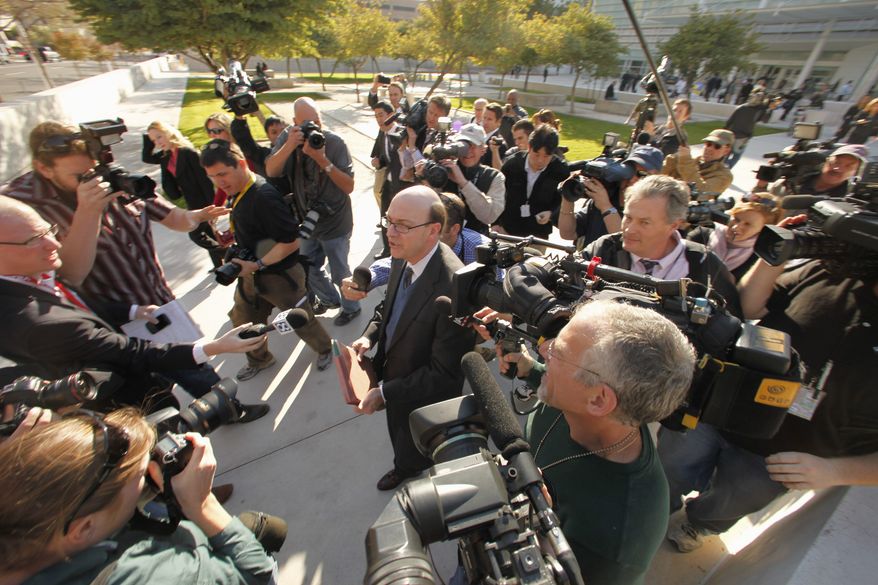U.S. District Attorney Patrick Cunningham (center) talks to the press after the initial court appearance of Jared Loughner in Phoenix on Monday. (Associated Press)
