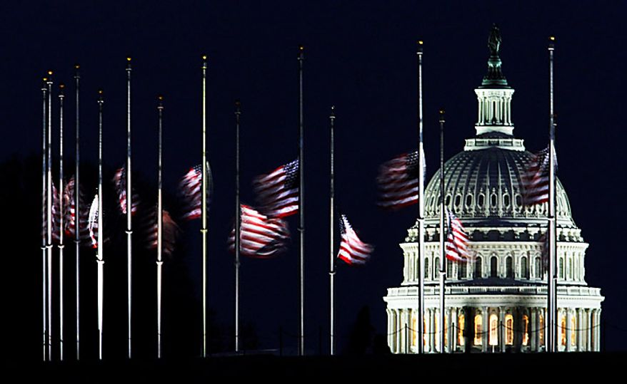 The U.S. Capitol dome backdrops American flags flying at half-staff at the foot of the Washington Monument on the National Mall in Washington, Sunday, Jan. 9, 2011. President Barack Obama ordered flags to be flown at half-staff at the White House and upon all public buildings and grounds, at all military posts and naval stations, and on all naval vessels of the Federal Government in the District of Columbia and throughout the United States and its Territories and possessions until sunset on Jan. 14, 2011. (AP Photo/Manuel Balce Ceneta)
