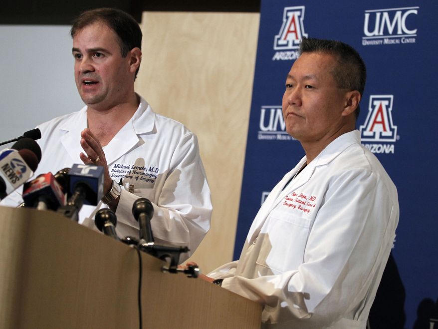 Dr. G. Michael Lemole Jr. (left) speaks about the condition of Rep. Gabrielle Giffords as Dr. Peter Rhee looks on during a news conference at the University Medical Center in Tucson, Ariz., on Sunday, Jan. 9, 2011. (AP Photo/Chris Carlson)