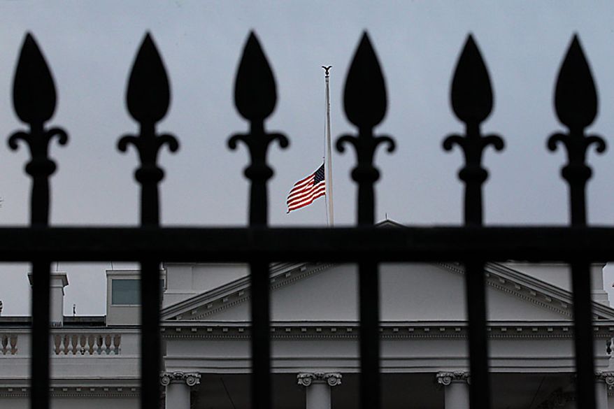 As ordered by President Obama, the American flag flies at half-staff over the White House at dawn, in Washington, Monday. Jan. 10, 2011, in observance of Rep. Gabrielle Giffords, Arizona Democrat, and the other victims of an assassination attempt against her in Saturday's shooting outside a Tucson, Ariz., supermarket. Mrs. Giffords, 40, remained in intensive care at a Tucson hospital after being shot in the head at close range. Among those killed were Arizona's chief federal judge, a 9-year-old girl interested in government, and one of Giffords' aides. (AP Photo/J. Scott Applewhite)