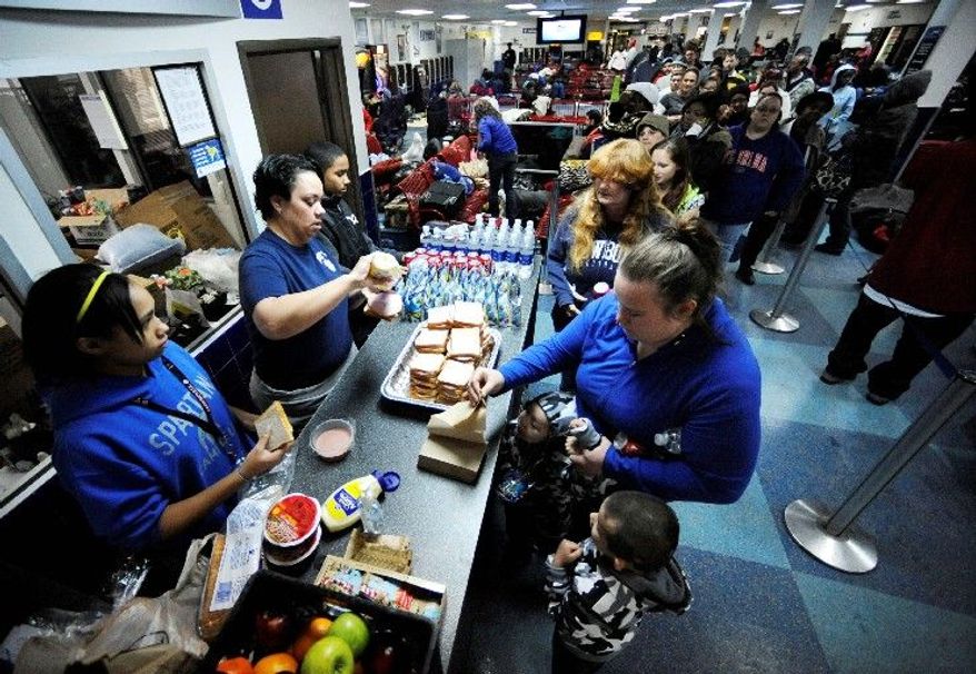Mary Garcia gets food for her family, stranded since Sunday, at the Greyhound bus terminal in Atlanta on Tuesday. (Associated Press)
