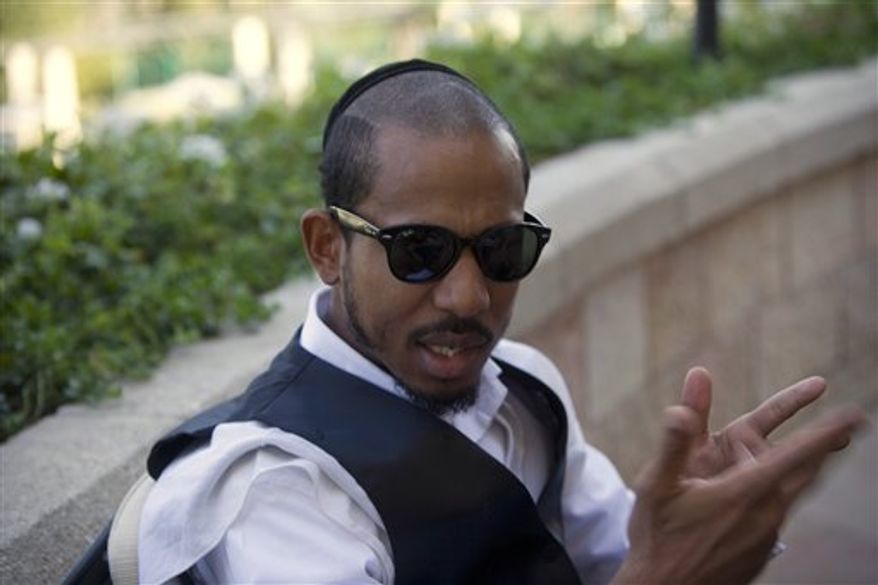FILE - In this Thursday, Nov. 11, 2010 file photo, U.S. rapper Jamal "Shyne" Barrow gestures during an interview with The Associated Press in Jerusalem. Reformed rapper and ex-convict Shyne said Tuesday, Jan. 11, 2011 that he is eager to collaborate with artists ranging from young Israeli musicians to hip hop moguls Kanye West and Jay-Z as he revives his career. (AP Photo/Tara Todras-Whitehill, File)