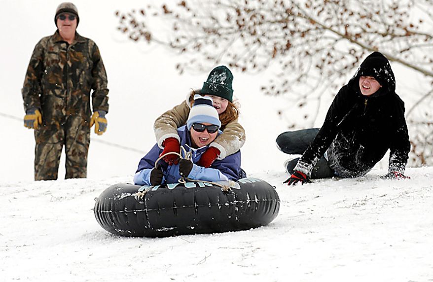 Heather Caton and her daughter Lily, 7, on top, head down the hill at Henderson, Ky. Municipal Golf Course Tuesday, Jan. 11, 2011. Snow fell across much of Kentucky on Tuesday, closing schools and slowing down motorists on their way to work. Snow plows and salt trucks were roaring on roadways early Tuesday morning, and officials said major thoroughfares were kept relatively clear of heavy snow. (AP Photo/The Gleaner, Darrin Phegley)